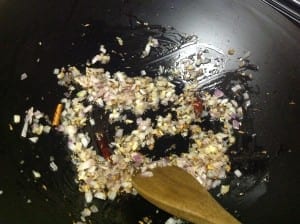 Onions, oil, garlic and ginger in a stir fry pan