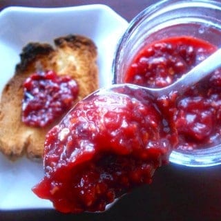 Tomato Jam made with raspberries. This is a very delicious take on regular raspberry jam. Adding tomatoes gives it a tangyness. Perfect breakfast jam recipe or use it as a sandwich spread