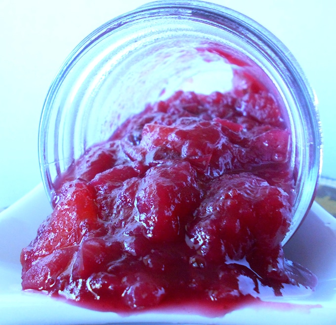 Front view of a sideways mason jar with vegan cranberry sauce