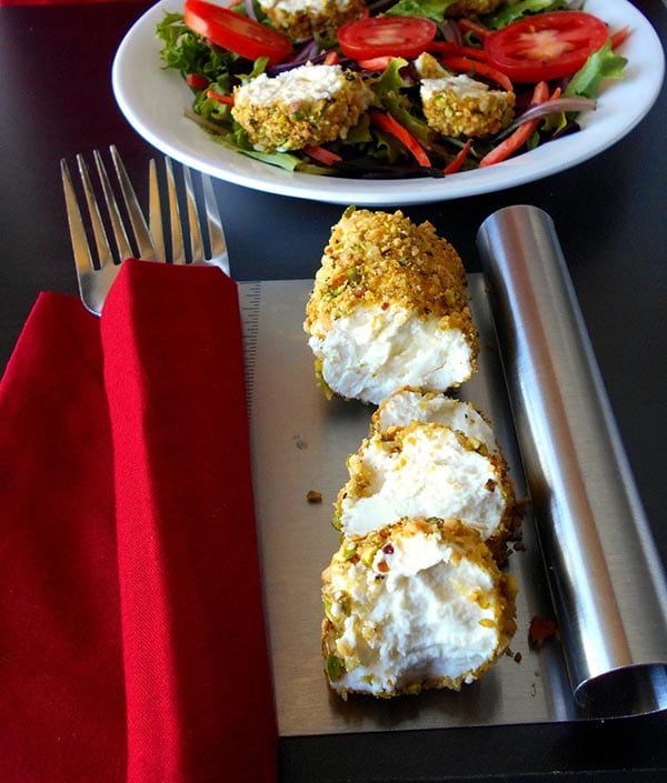 Front View of Goat cheese Log coated in pistachio and cardamom and cut into rounds