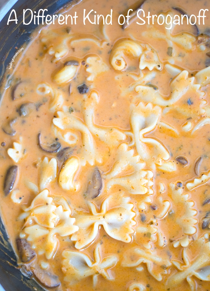 Overhead view of a pan filled with Creamy Mushroom Stroganoff with Pumpkin with farfalle pasta and elbow pasta