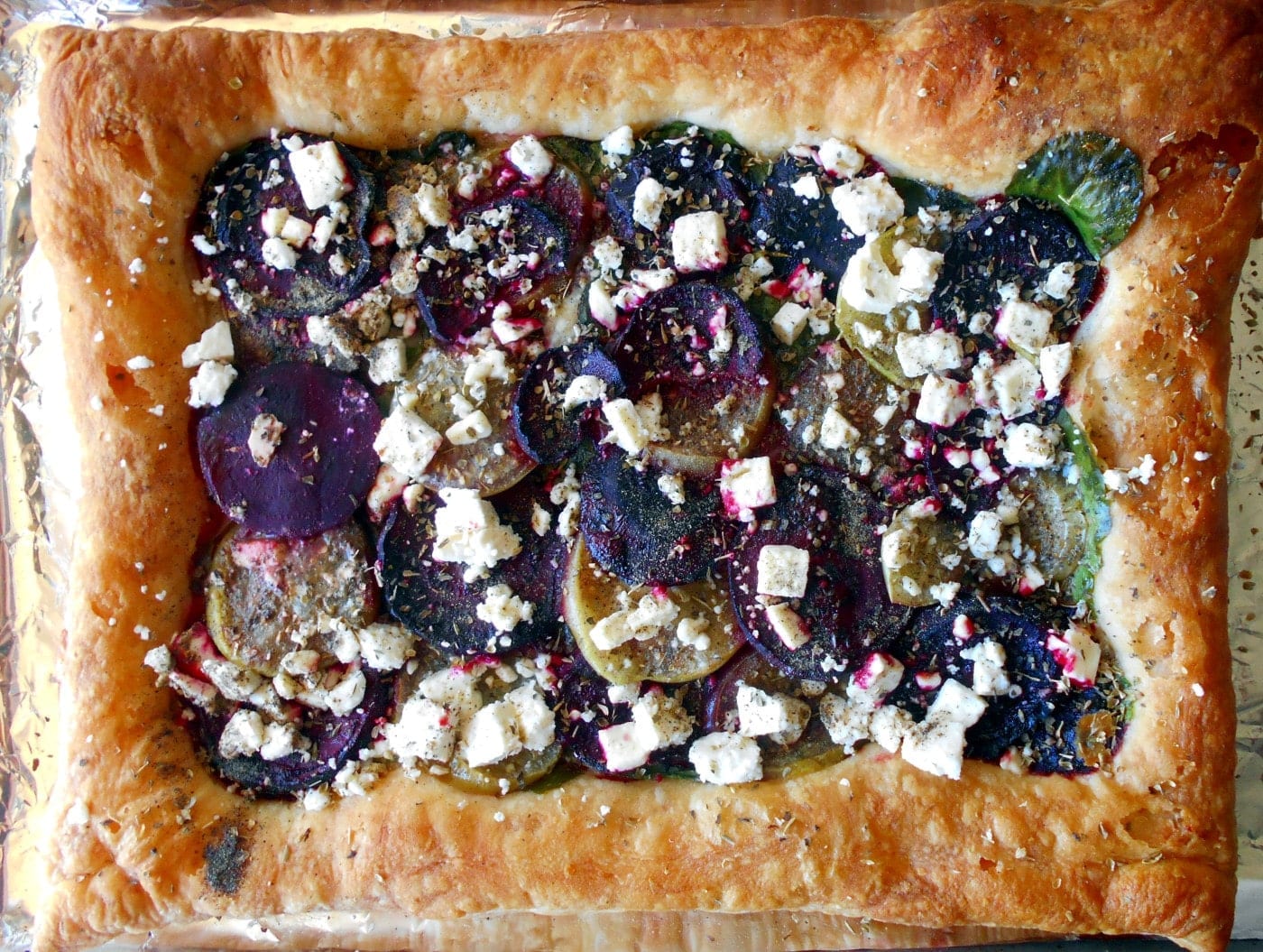 Overhead view of a wholly baked puff pastry beet tart that is oven roasted