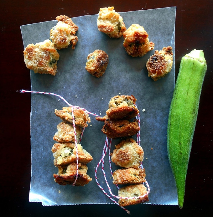 Overhead View of Baked Okra on a Wax Paper. One Green Okra on the Side