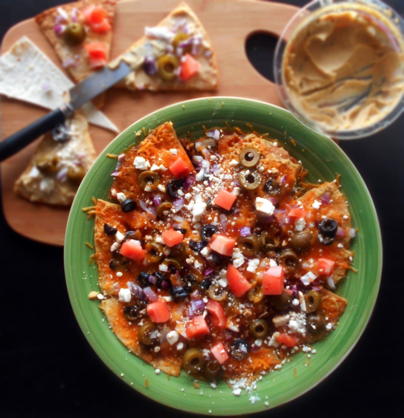 Greek Nachos Recipe made with Hummus, olives, tomatoes, feta and cheddar cheese. Mediterranean Diet Recipe