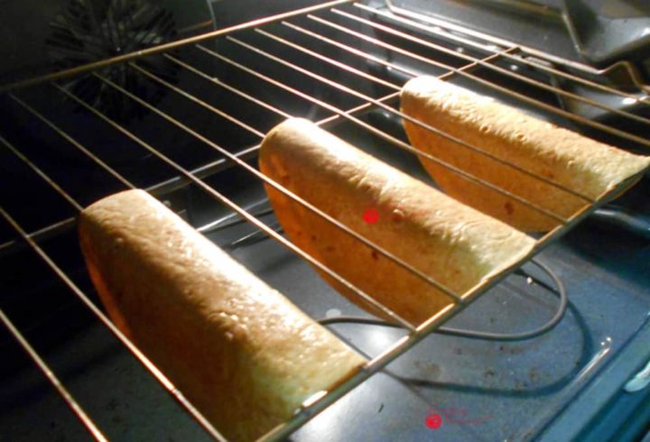 Oven View of 3 Tortillas Hung Upside Down in the Rails of Oven Racks