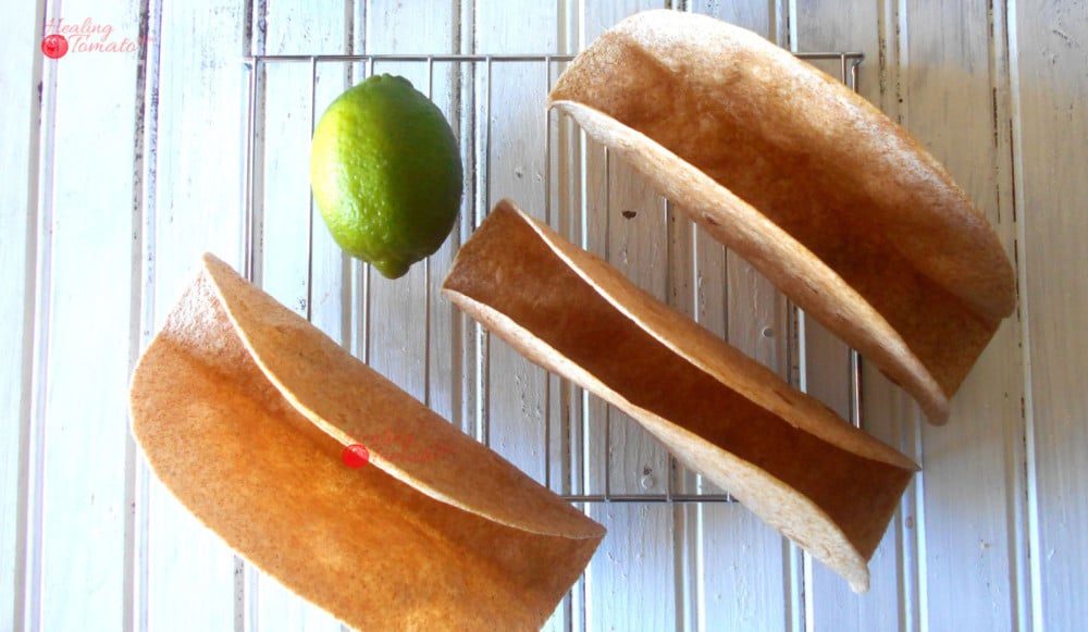 Overhead View of 3 Homemade Taco Shells Grande on a Cooling Rack with 1 Lime in the Middle