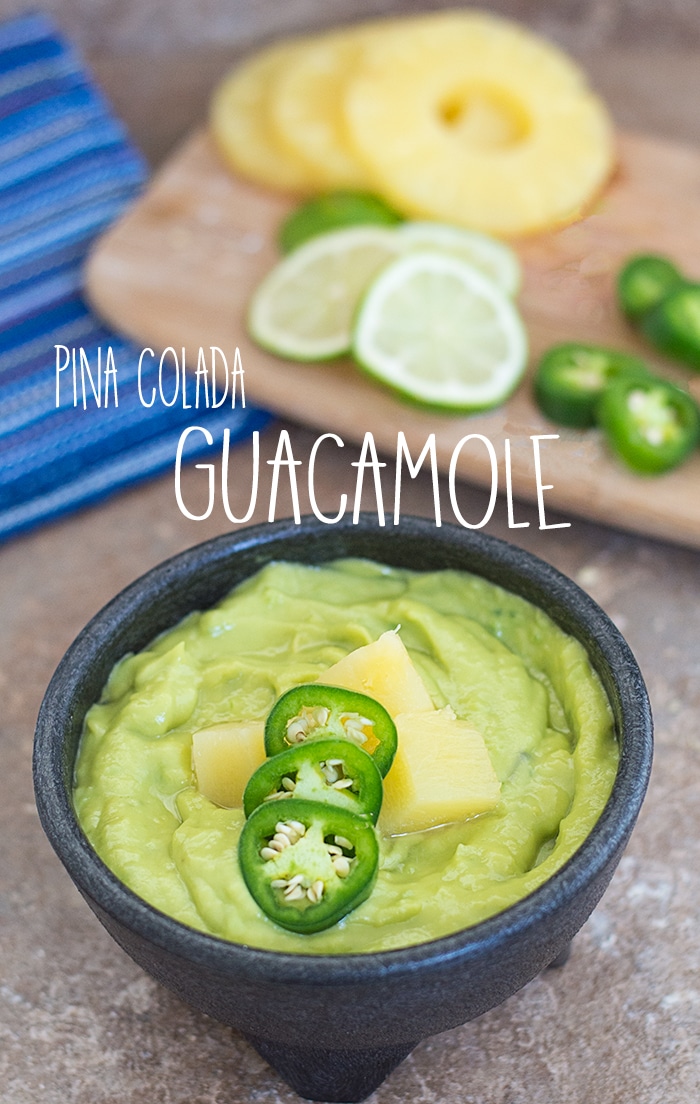 Front view of pina colada guacamole in a black bowl