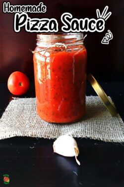 Front view of glass jar filled with a red sauce.