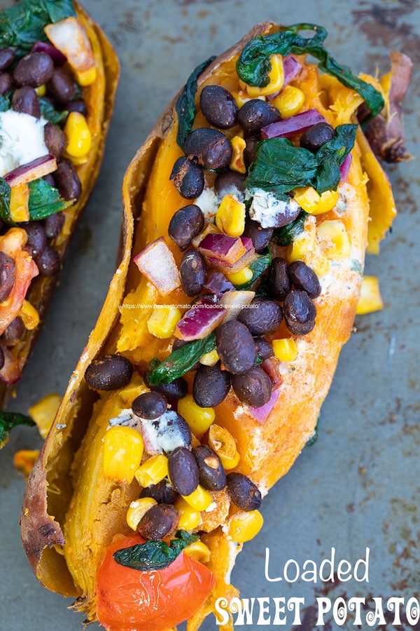 Top view of one stuffed sweet potatoes on a gray baking tray