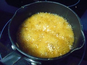Honey and butter brought to a boil in a pan - Homemade granola bars