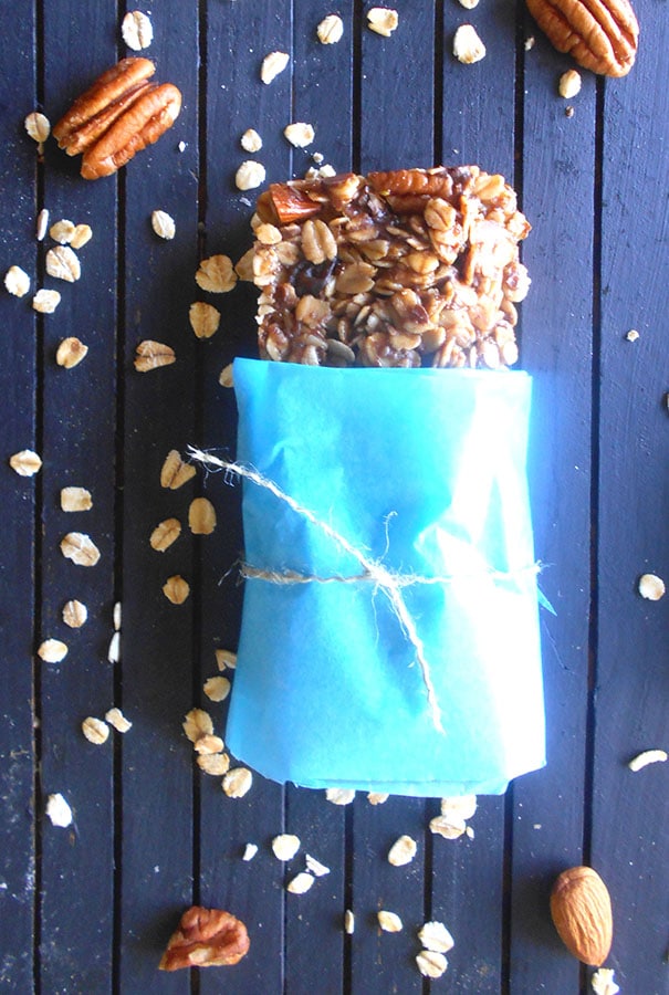 Overhead view of a homemade granola bar with pecans and oatmeal scattred