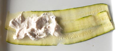 Yogurt spread on part of the zucchini rolls