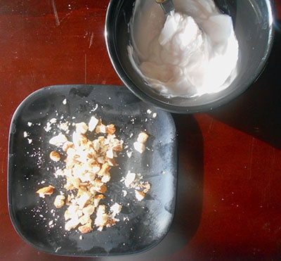 Crushed nuts with a side of yogurt to be used in zucchini rolls