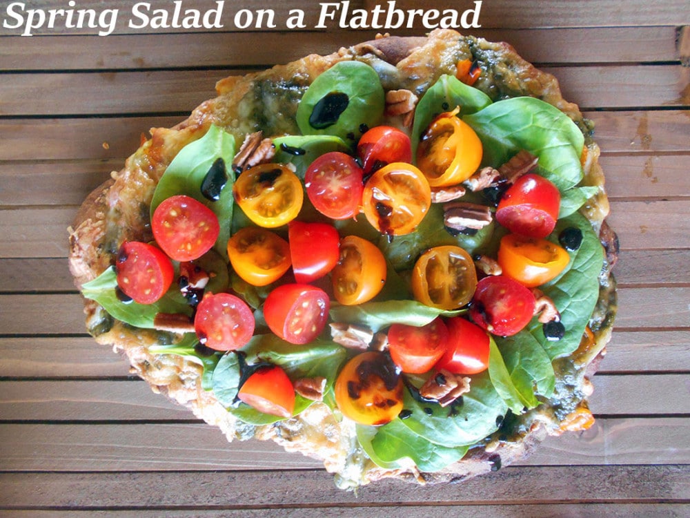 Spring Salad On A Flatbread - Made with baby spinach, cherry tomatoes and pecans. Drizzled with Balasmic Reduction Sauce. Flatbread made with Pesto, mini sweet peppers and cheese https://www.healingtomato.com/2015/04/08/spring-salad-on-flatbread-pizza