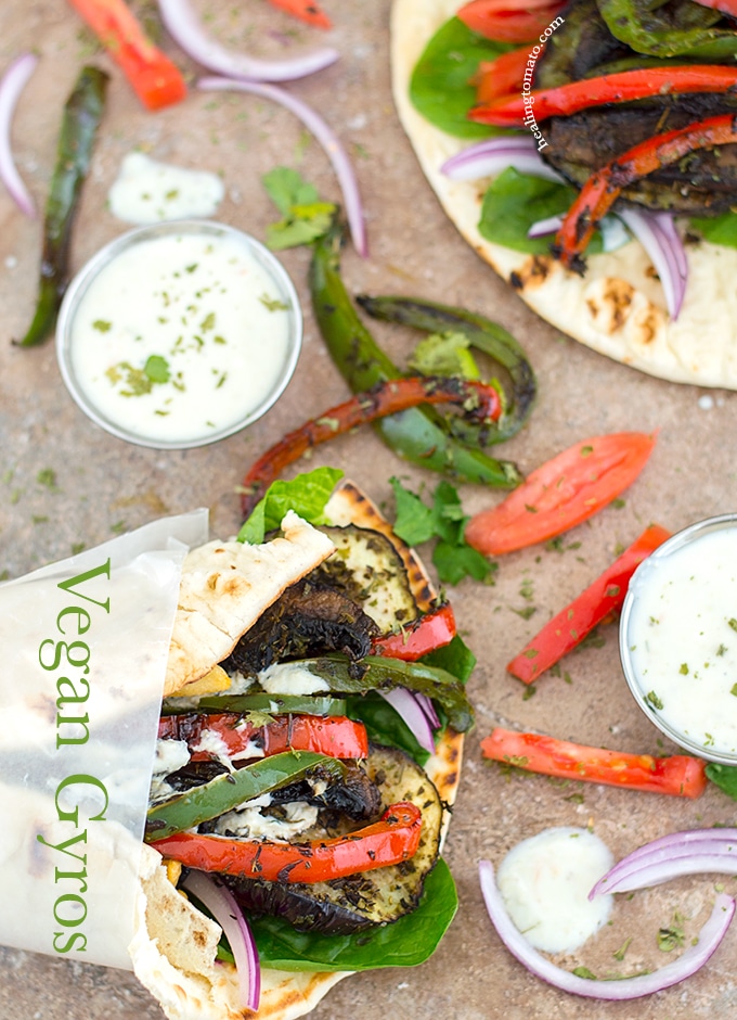 Overhead View of a Wrapped Pita Filled with Grilled Veggies and an Open Flatbread Filled with Grilled Veggies.