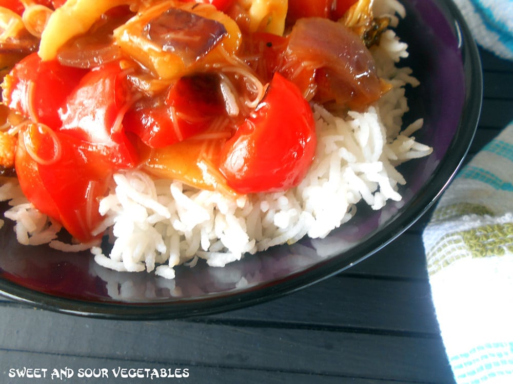 Closeup view of a bowl with rice and sweet and sour vegetables