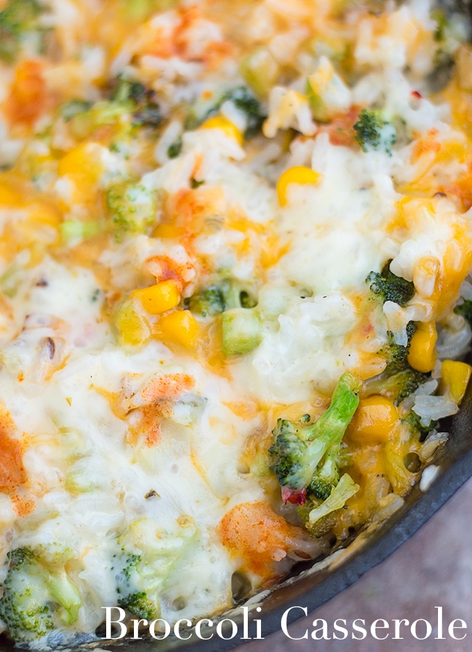 Closeup View of a Black Skillet Filled with Broccoli Rice Casserole and Topped with Melted Cheese