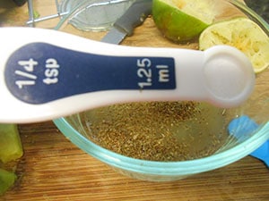 1/4 tsp of salt measuring spoon held on top of the lime bowl - Kale Salad