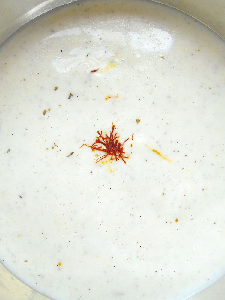 Closeup view of a plastic bowl with Yogurt mayo. Saffron for garnish - Saffron Yogurt Mayo