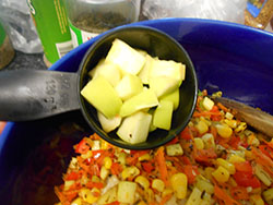 Cubed Apples added to a stir fry pan - Vegan Meatloaf recipe