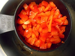 Chopped Red Bell Peppers added to a stir fry pan - Vegan Meatloaf recipe