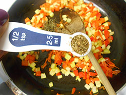 Dried Rosemary added to a stir fry pan - Vegan Meatloaf recipe