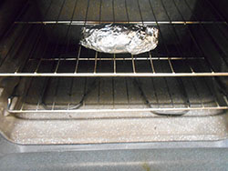 A Sweet Potato Wrapped in Aluminium Foil and placed in the top rack of the ovenBaked Sweet Potato Pulp in a clear container- 5 Tips on Baking The Perfect Sweet Potato