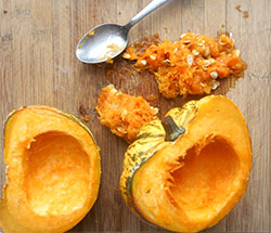 The insides of the baked carnival squash removed