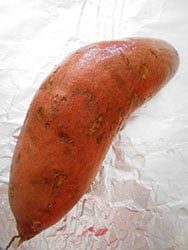 A thouroughly cleaned sweet potato on a foil