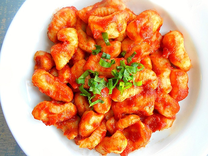 Closeup View of a White Plate Filled With Gnocchi in a Red Pasta Sauce