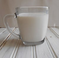 Front view of a glass filled with milk - Boozy Hot Chocolate
