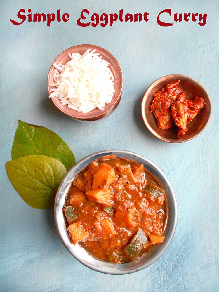 overhead view of eggplant curry with rice and pickles