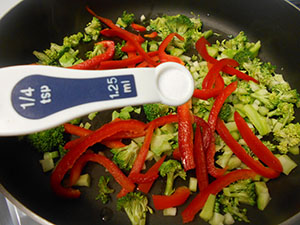 Overhead view of a 1/4 tsp measuring spoon over the broccoli and bell peppers - Vegan Pad Thai Recipe