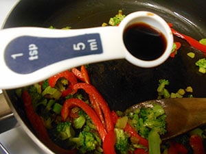 Overhead view of 1 tsp measuring spoon above the broccoli - Vegan Pad Thai Recipe