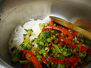 Cooked veggies added to the cooked rice noodles in the pan - Vegan Pad Thai Recipe