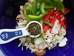 Dried parsley being added to the bowl 