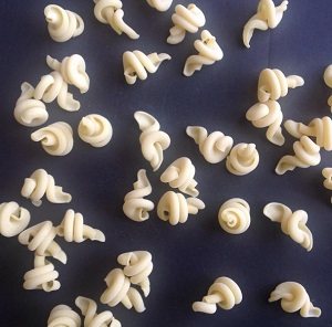 Dry tortolle pasta on a black background