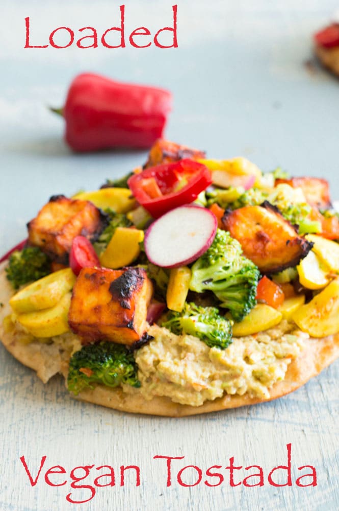 This LOADED vegan tostada is made with salsa marinated tofu and filled with delicious veggies. This is a perfect vegan dinner idea for any weeknight.