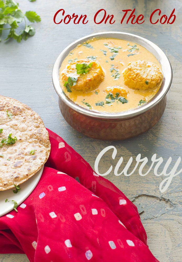 75° View of a Copper Bowl at the Top of the Photo Filled with Yellow cob Curry.