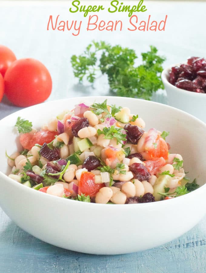 Front view of navy bean salad in a white bowl