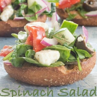 A very simple Greek spinach salad topped on whole wheat mini bagels. This is a healthy and delicious vegetarian lunch that you can eat anywhere