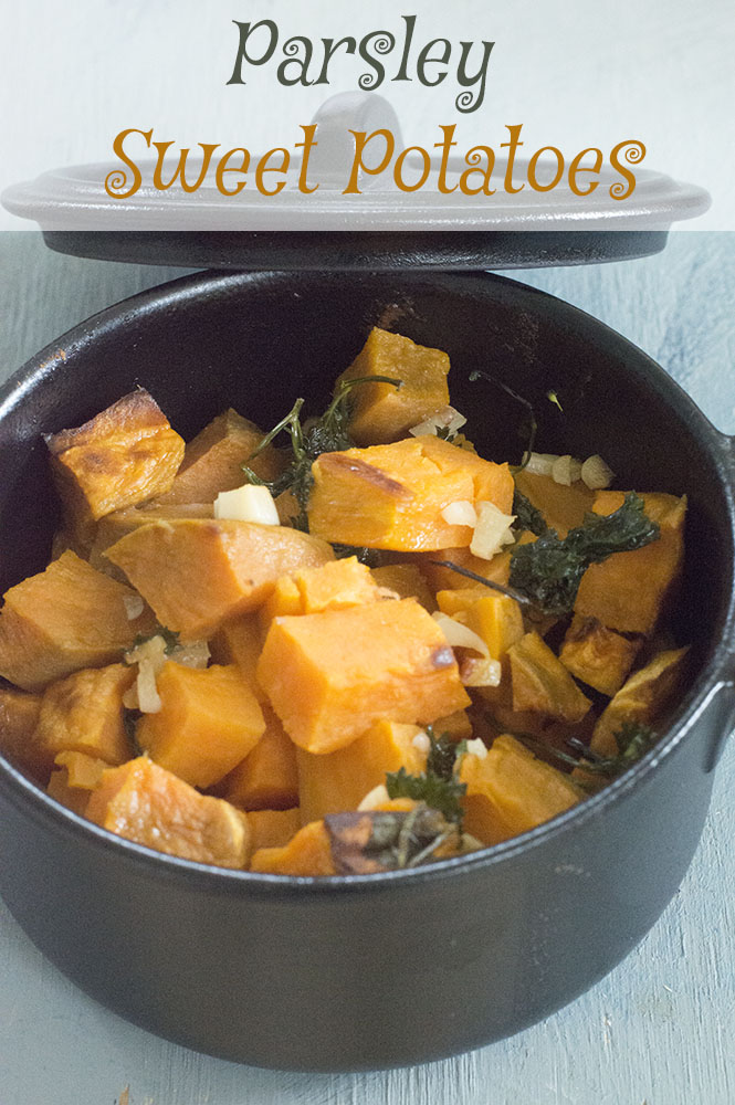 A small cast iron pot with parsley sweet potato in it - vegan tapas