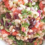 Top view of navy bean salad in a white bowl