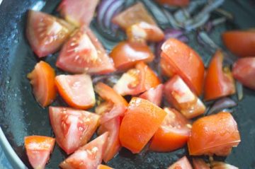 Closeup of tomatoes put into the pan - Lentil Potato Medley