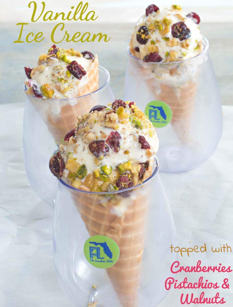 Ice cream cone in a glass and topped with pecans, cranberries