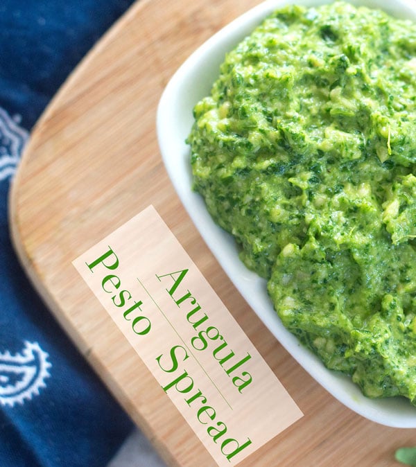 Closeup view of arugula pesto spread in a small white rectangle dish