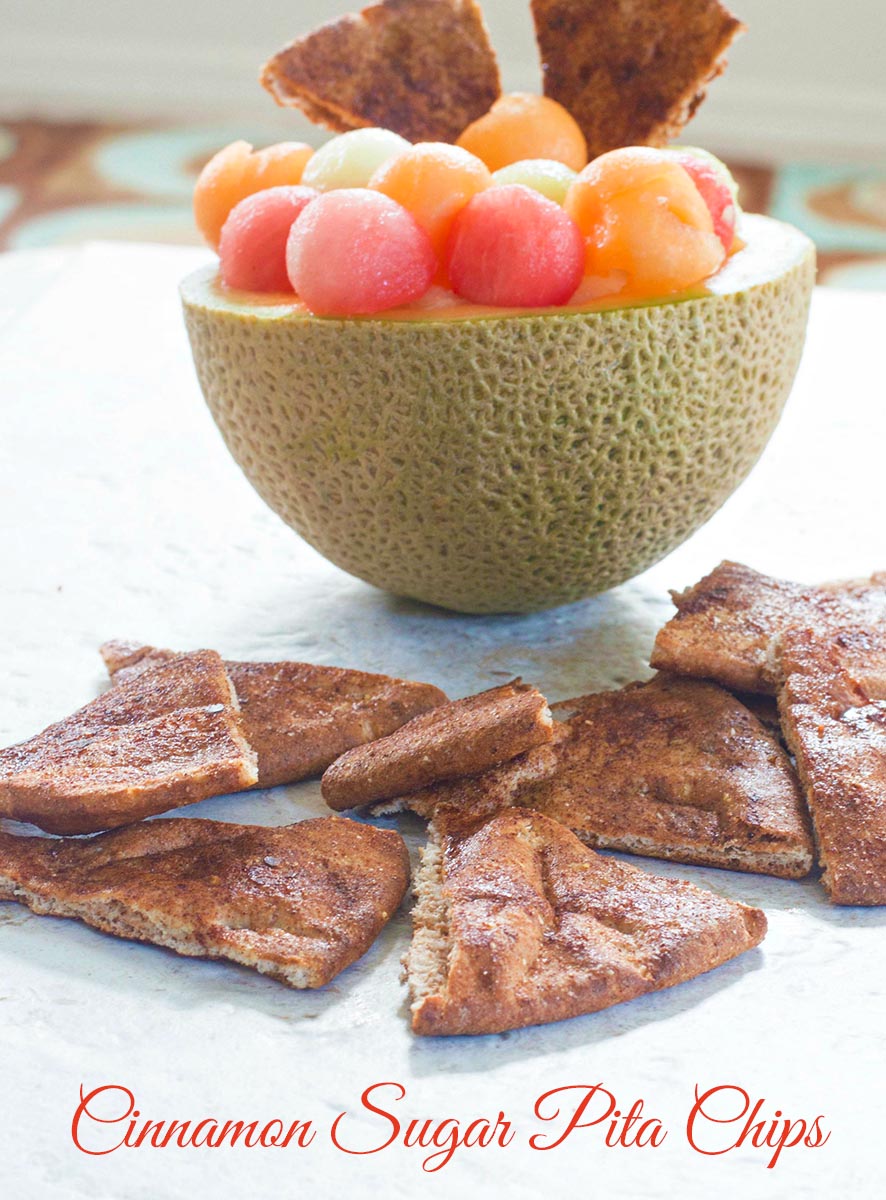 Front view of cinnamon pita chips next to a cantoloupe with melon balls