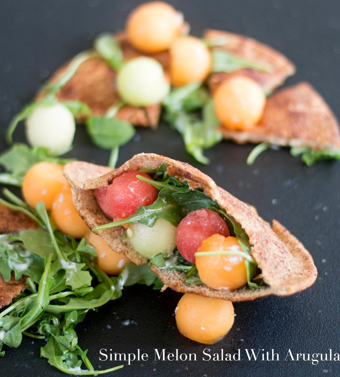 Front view of melon balls with arugula inside a sweet pita bread