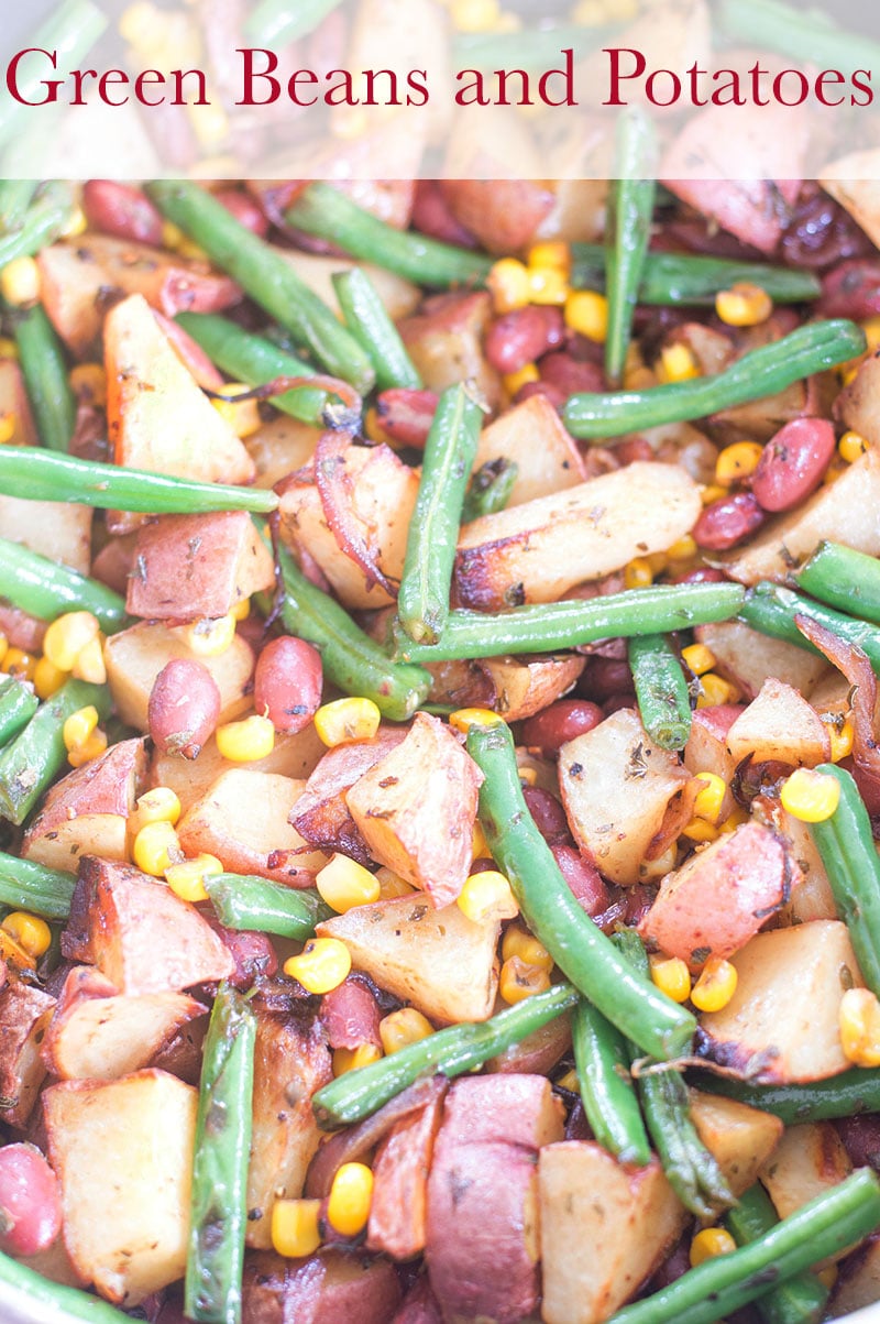 Overhead view of a pan filled with cooked green beans, potatoes, corn and red kidney beans
