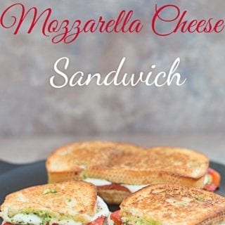 Front View of 2 Mozzarella Cheese Sandwiches on a Skillet. One of Those Sandwiches has Been Cut into Half
